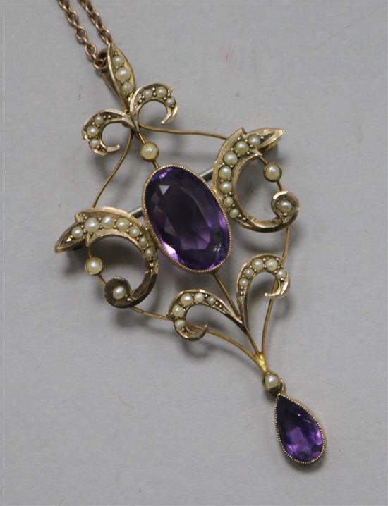 An Edwardian 9ct gold, amethyst and seed pearl set pendant/brooch, on a 9ct gold fine link chain, pendant 6cm.